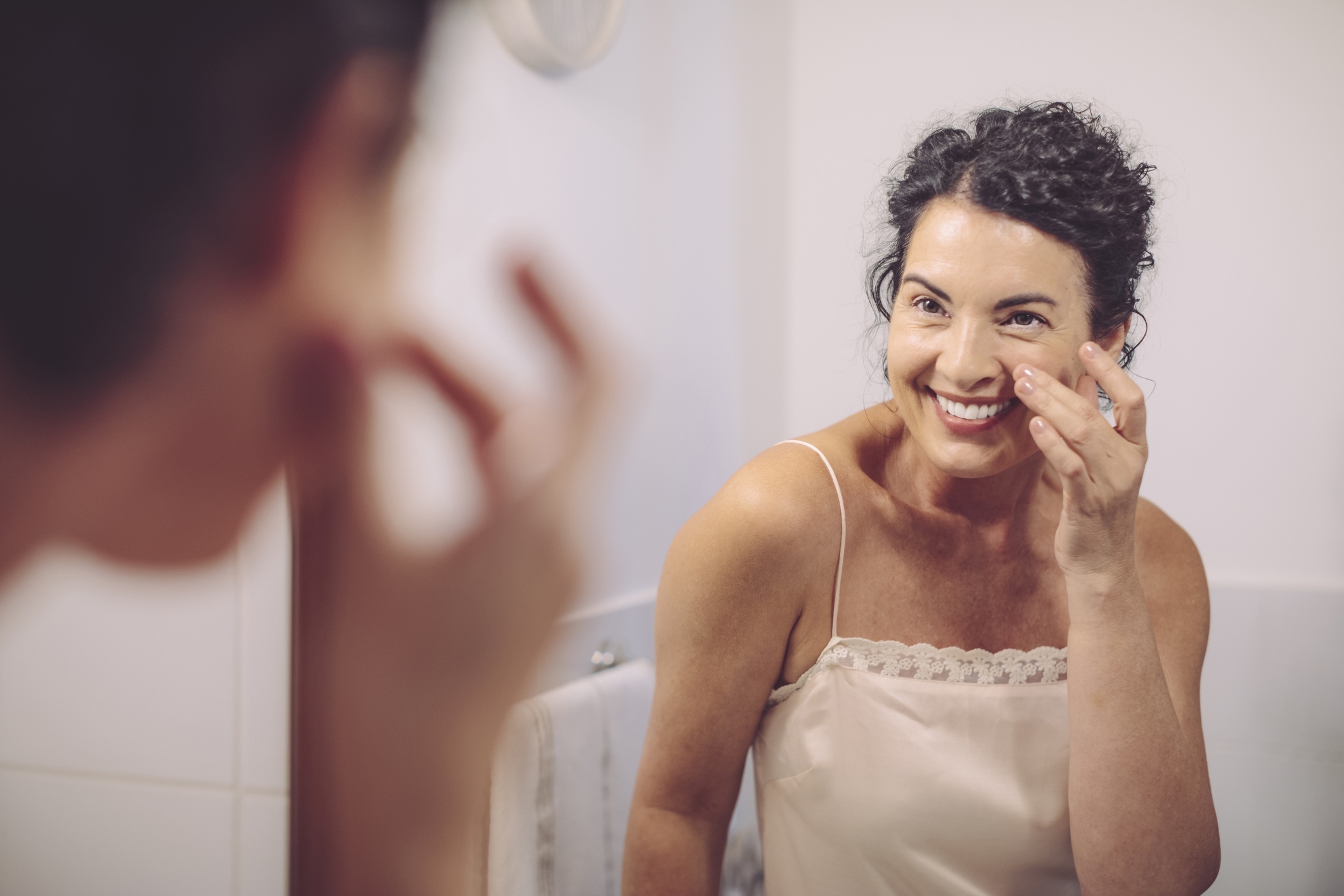 Woman applying face cream