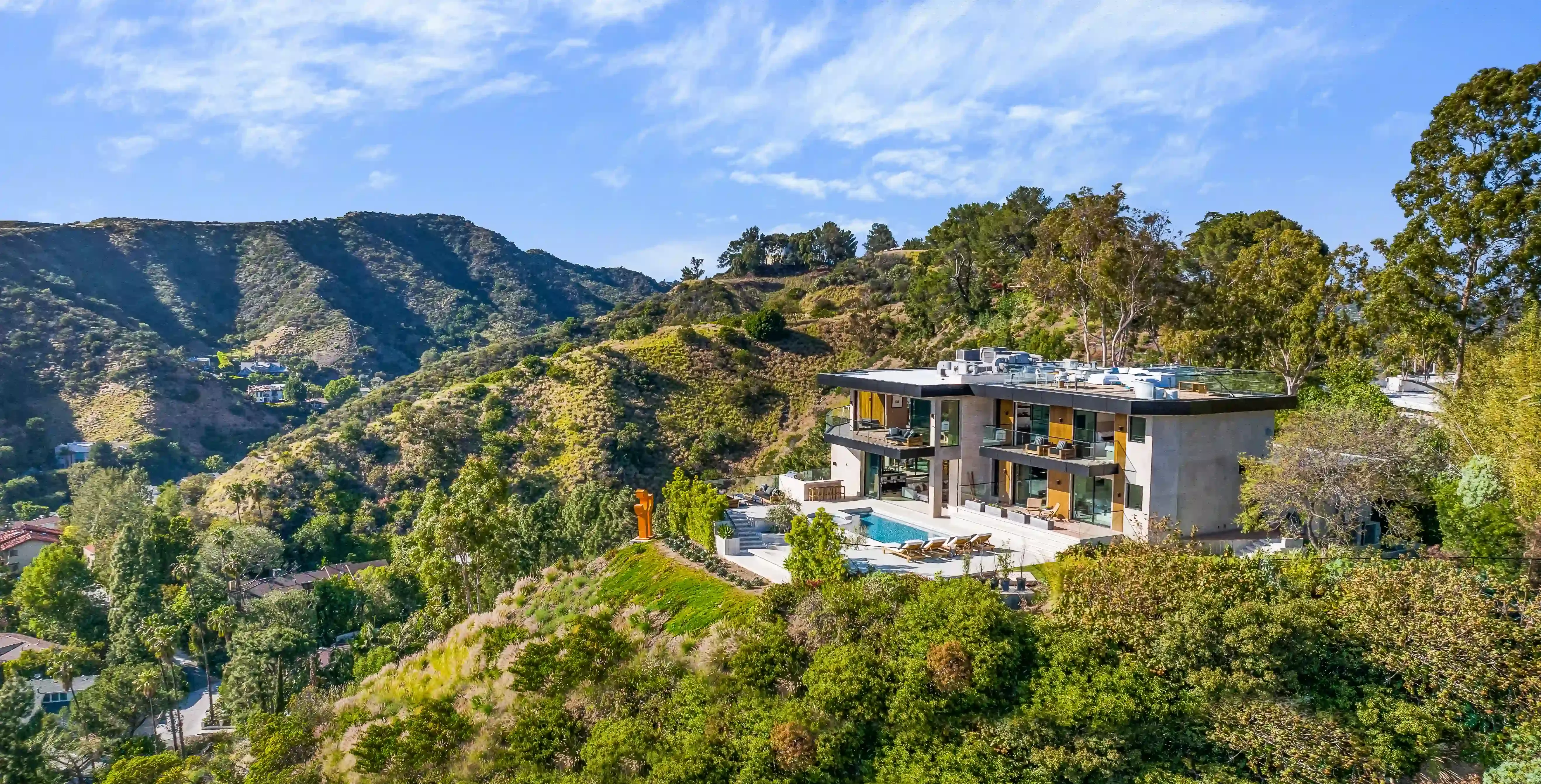 Birdseye view of luxury estate home with outdoor pool in the hills