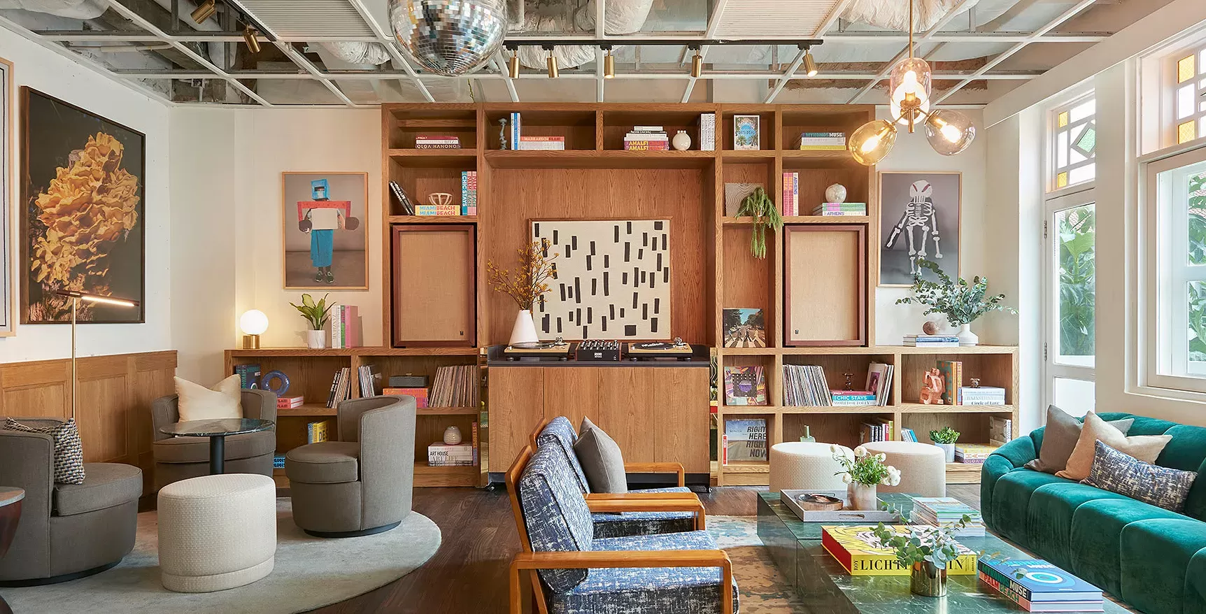 Modern interior seating area with a range of chairs, sofas, images and cabinets