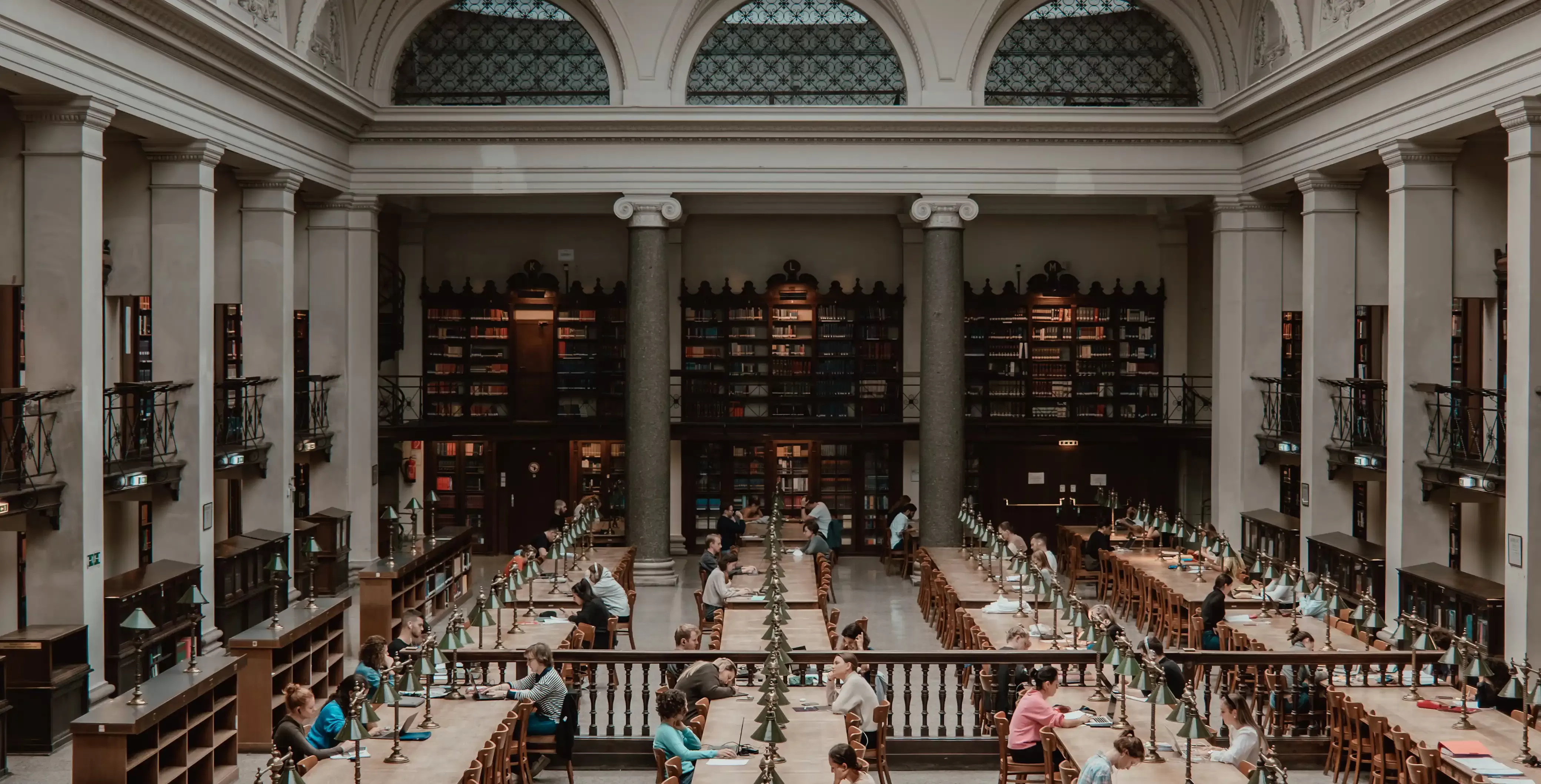 Overview of luxurious library full of people