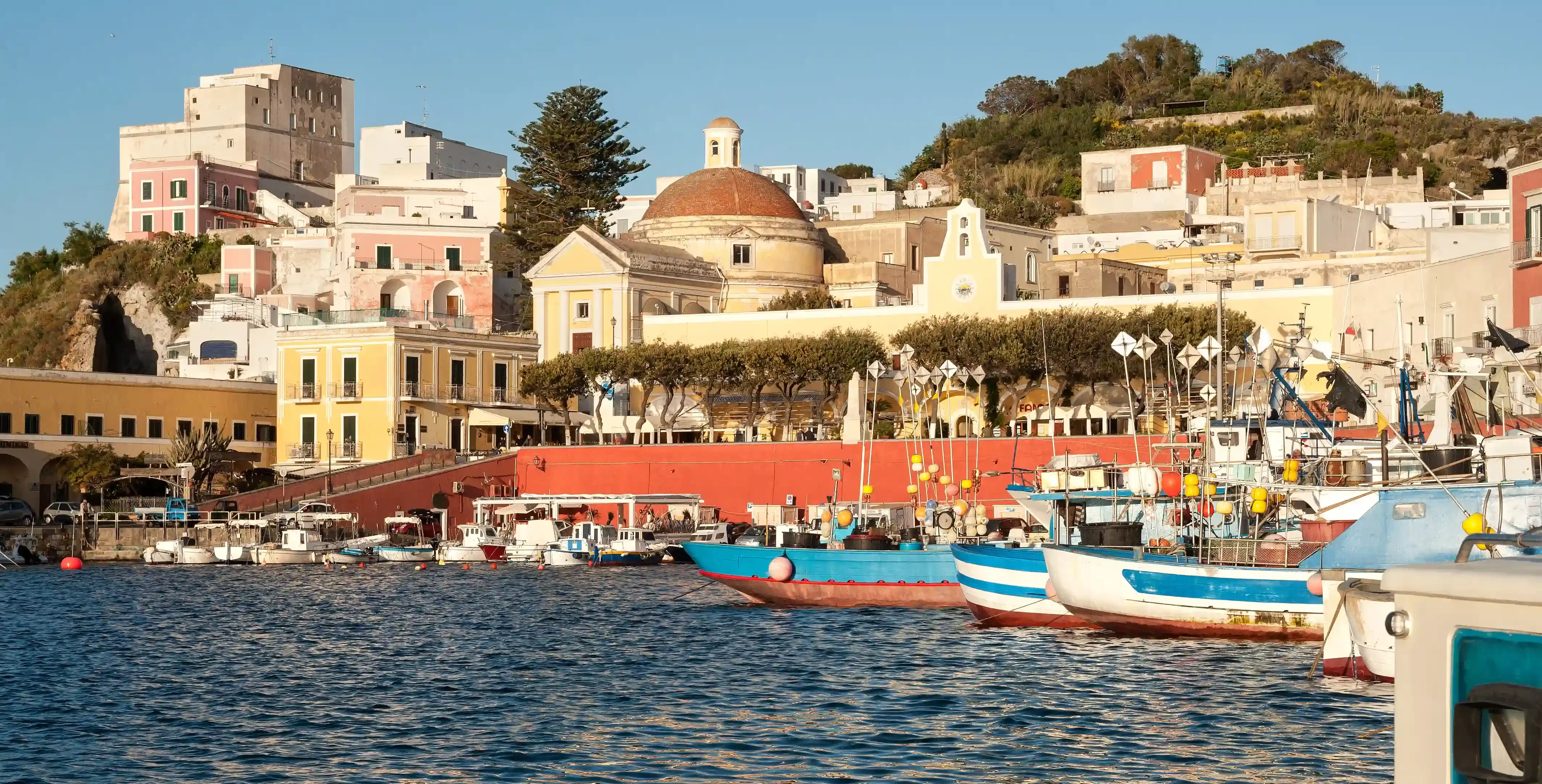 View over sea and shore line buildings and boats in Italy