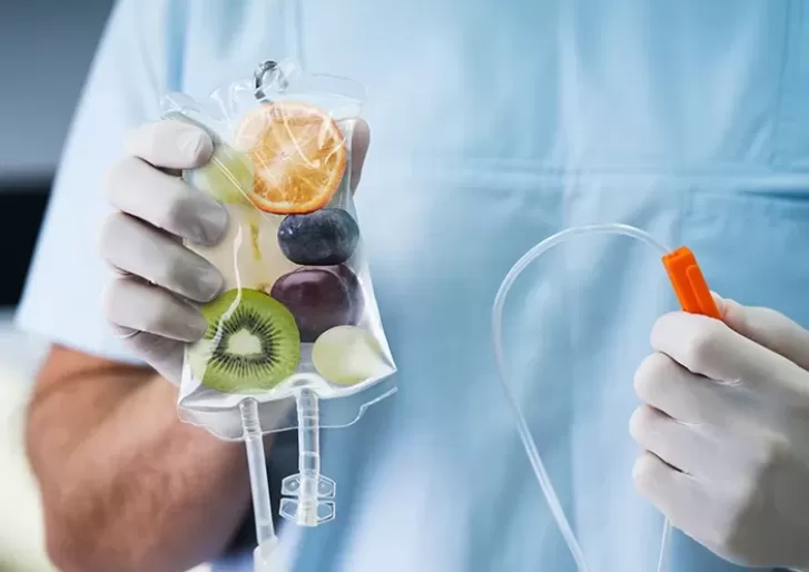 Doctor holding IV drip full of fruit