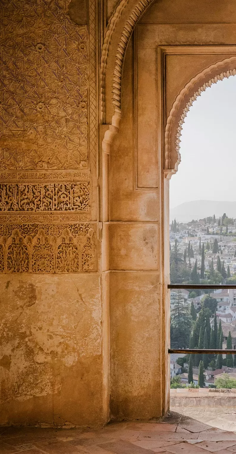 Arched ancient wall with view of city